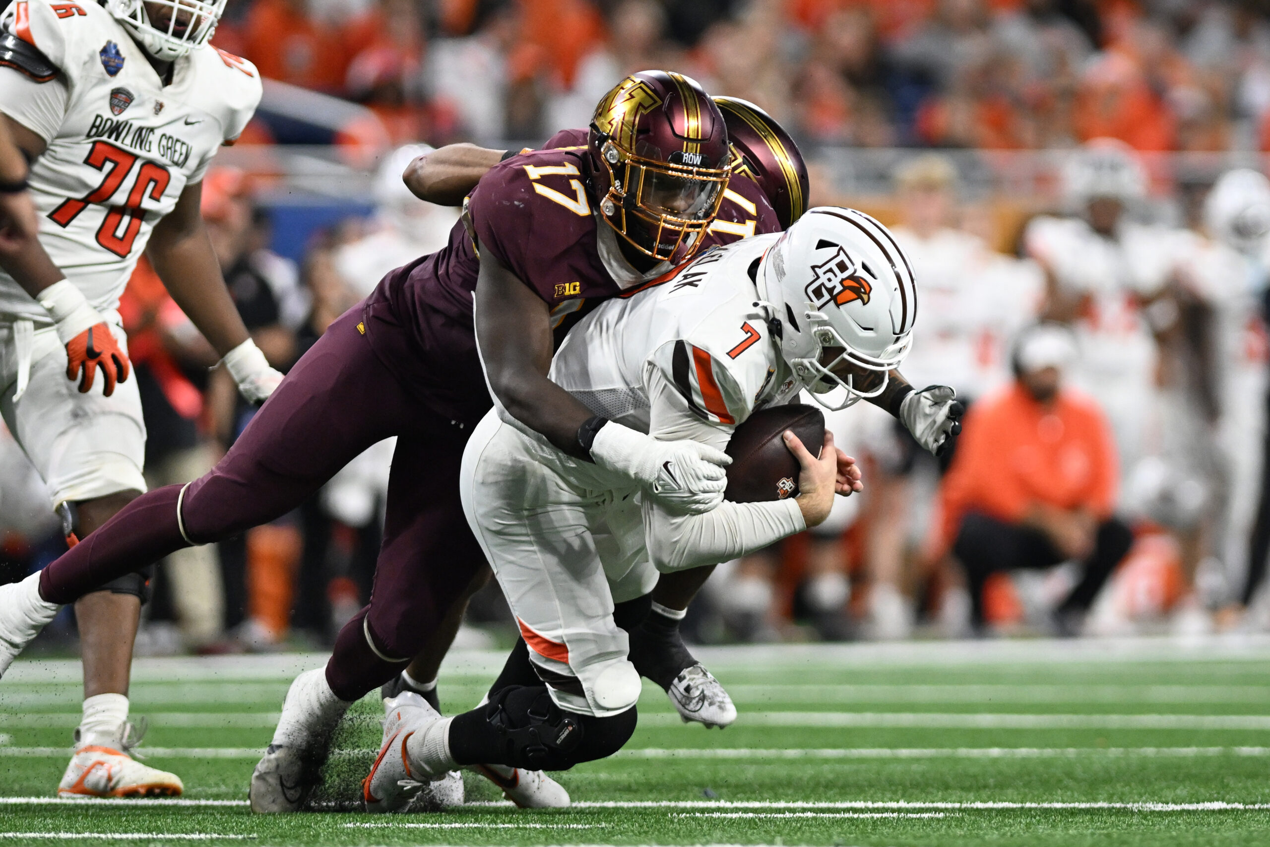 Minnesota Golden Gophers defensive lineman Jah Joyner (17) and defensive back Tre'Von Jones (2) sack Bowling Green Falcons quarterback Connor Bazelak (7) at Ford Field.