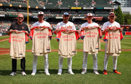 Head athletic trainer Brian Ebel, Jordan Westburg #11, Anthony Santander #25, Adley Rutschman #35, and Gunnar Henderson #2 of the Baltimore Orioles are recognized for being selected to the 2024 All-Star game before the game against the New York Yankees at Oriole Park at Camden Yards on July 14, 2024 in Baltimore, Maryland.