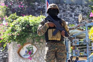 A Haitian police officer stands guard outside of the presidential residence on July 7, 2021 in Port-au-Prince, Haiti.