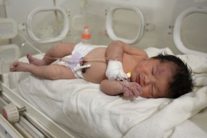 A newborn baby who was found still tied by her umbilical cord to her mother and pulled alive from the rubble of a home in northern Syria following a deadly earthquake, receives medical care at a clinic in Afrin, on February 7, 2023