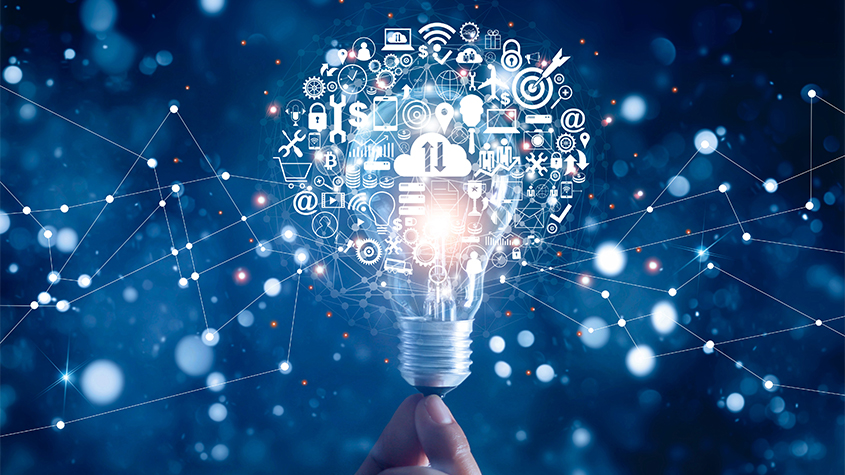 hand holding light bulb and digital marketing symbols as an abstract representation of innovative ideas