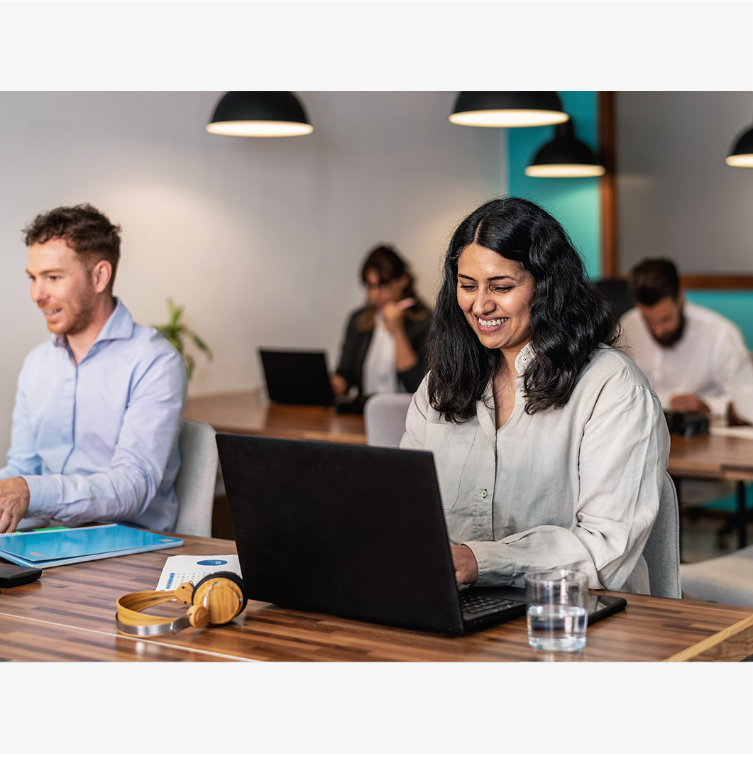 a man and a woman working on the laptop